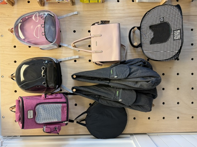 Pet carriers, backpacks and slings on display