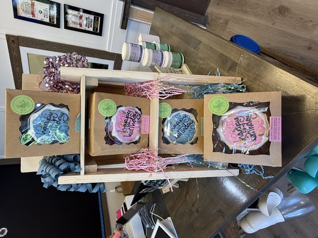 Packaged dog birthday cakes on display